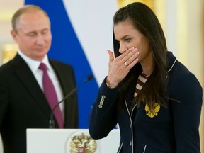 Russian pole-vaulter and Olympic champion Yelena Isinbayeva wipes away tears after speaking to fellow athletes at the Kremlin Wednesday.