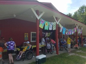 A horse barn is transformed into a crafts center at FA Woodstock. Children and adults made tie-die T-shirts together while inside the barn horses were routinely taken out for children to ride.