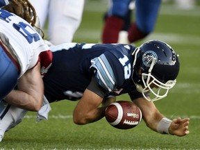 Toronto Argonauts quarterback Ricky Ray loses control of the ball as he's tackled by the Montreal Alouettes during first half CFL action in Toronto on Monday, July 25, 2016.