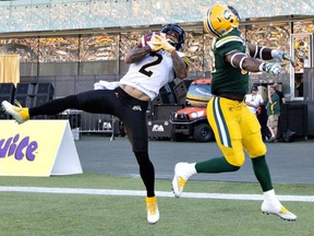 Hamilton Tiger-Cats' Chad Owens makes the catch for the two- point conversion in front of the Eskimos' Kenny Ladler during second half CFL action in Edmonton on Saturday night.