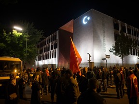 People demonstrate  against a coup attempt in Turkey, in front of the Turkish embassy in Berlin Germany,  early Saturday July 16, 2016. German politicians fear rising tensions among the country's millions of Turkish immigrants.