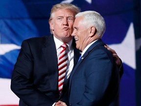 Republican presidential Candidate Donald Trump kisses Republican vice presidential nominee Mike Pence after Pence's acceptance speech at the Republican National Convention in Cleveland on Wednesday.