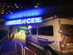 A police car stands in front of the emergency entrance of Grenoble Hospital, near where a mother and her three daughters were treated after a knife attack at an Alpine resort