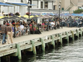 People gather on the patio at a waterfront pub in Halifax in 2015.