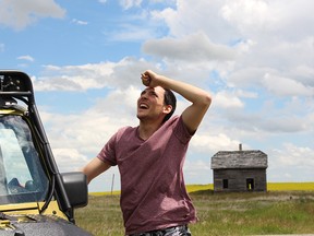 Storm chaser Braydon Morisseau watches a developing funnel cloud on a remote stretch of road outside Granum, Alta.