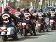 Members of the Hells Angels biker gang leave Park Memorial Chapel in Edmonton Thursday after the funeral of one of their own, Kenny Mire.