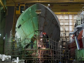 Technicians work on a hull at the Irving shipyard in Halifax on March 7, 2013.