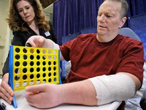 Jeff Kepner works with a physical therapist following his double hand transplant in 2009.