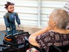 Elizabeth Graner, a resident of long-term care home One Kenton Place, talks to Ludwig the robot.