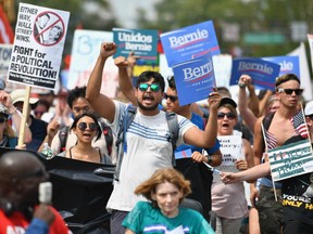 Bernie Sanders supporters march through downtown Philadelphia on the first day of the Democratic National Convention Monday.