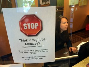 A sign warns of the dangers of measles in the reception area of a pediatrician's office in Scottsdale, Arizona.