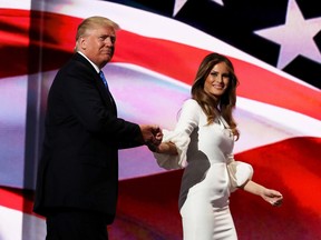 Presumptive Republican presidential nominee Donald Trump stands with his wife Melania after she delivered a speech on the first day of the Republican National Convention.