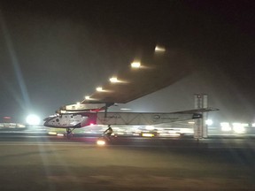 The Solar Impulse 2 plane lands in an airport in Abu Dhabi, United Arab Emirates, early Tuesday, July 26, 2016.