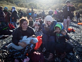 A Yazidi refugee family from Iraq cries shortly after arriving on  a vessel from Turkey on the Greek island of Lesbos last fall.