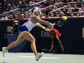 Magda Linette of Poland hits a backhand shot against Petra Kvitova of Czech Republic during Day 1 action at the Rogers Cup women's tournament in Montreal.