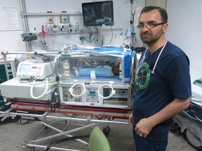 Dr. Khorshid Mohammad stands next to the transportation cooling device in this photo taken Monday, July 25, 2016. Newborns who are deprived of oxygen at birth are kept in a cooling blanket for 72 hours until her condition improved.