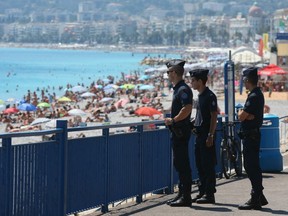 French police officers patrol on the famed Promenade des Anglais in Nice, southern France, three days after a truck mowed through revelers, Sunday, July 17, 2016. French authorities detained two more people Sunday in the investigation into the Bastille Day truck attack on the Mediterranean city of Nice that killed at least 84 people.