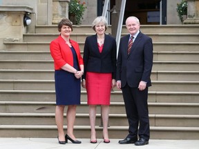 Britain's Prime Minister Theresa May, centre,  is greeted by Northern Ireland's First Minister Arlene Foster, left and Deputy First Minister Martin McGuinness