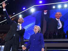 President Barack Obama waves alongside Presidential nominee Hillary Clinton during the third night of the Democratic National Convention.