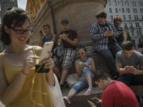 Gamers play Pokemon Go on Fifth Avenue in New York on July 13, 2016