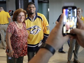 Nashville Predators defenceman P.K. Subban poses for a photo with fan Diane Fashing, left, after appearing at a news conference Monday, July 18, 2016, in Nashville, Tenn.