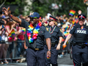 Police Chief Mark Saunders, left, marches in Toronto's 2016 Pride parade.