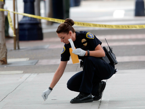 San Diego Police collect evidence at the scene where a homeless man was struck in the head with a hammer like object by a man on a bicycle, July 13, 2016 in San Diego.