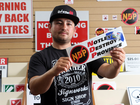 Mark Tanigami, owner of Frontier Signworks, saw his safety and sign business plummet until he created Anti NDP signs in his shop in Brooks on July 26, 2016.