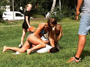 Swedish police officer Mikaela Kellner pins a man to the ground who is suspected to have stolen a friend's mobile phone in Stockholm Sweden, Wednesday, July 27, 2016. She was off duty but that didn't stop her from apprehending the man.