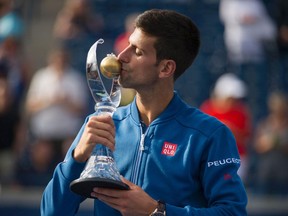 Novak Djokovic accepts the trophy after defeating Kei Nishikori of Japan to win the Rogers Cup in Toronto on July 31, 2016.