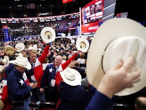 Delegates from Texas wave their hats in the air on the first day of the Republican National Convention in Cleveland, Ohio, on Monday.