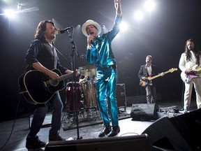 Frontman of the Tragically Hip, Gord Downie, centre, leads the band through a concert in Vancouver, Sunday, July, 24, 2016.