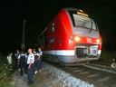 Police officers stand by a regional train in Wuerzburg southern Germany on July 18, 2016 after a man attacked train passengers with an axe.