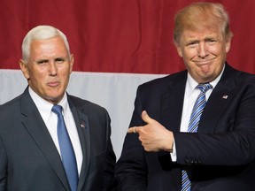 U.S. Republican presidential candidate Donald Trump, right, and Indiana Governor Mike Pence, left, take the stage during a campaign rally at Grant Park Event Center in Westfield, Indiana on July 12, 2016.