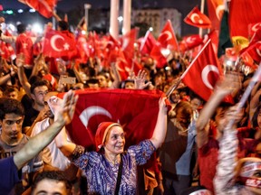 Supporters of Turkish President Recep Tayyip Erdogan wave flags as they gather in Istanbul's main Taksim Square on July 17, 2016, Turkey. Clean up operations are continuing in the aftermath of Friday's failed military coup attempt which claimed the lives of more than 290 people. In raids across Turkey 9,000 people have been arrested in relation to the failed coup including high-ranking soldiers and judges, Turkey's Justice Minister Bekir Bozdag has said.