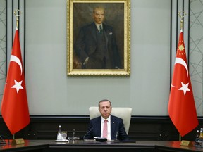 Under a portrait of Turkish Republic founder Mustafa Kemal Ataturk,Turkey's President Recep Tayyip Erdogan chairs the cabinet meeting, in Ankara, Turkey, Monday, July 25, 2016.