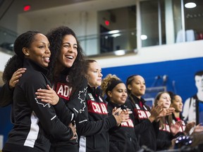Nirra Fields, left, and Kia Nurse embrace during a press conference on Friday, July 22, 2016 announcing the 12 atheletes nominated to represent Team Canada in women's basketball for the Rio 2016 Olympic Games.