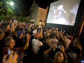 A crowd watches The Tragically Hip perform the song Bobcaygeon, in Bobcaygeon, Ont., on Saturday.