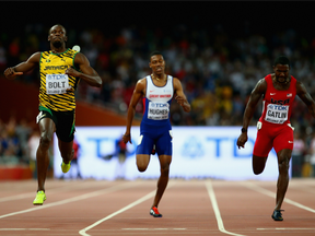 Usain Bolt (left) crosses the finish line just ahead of Justin Gatlin (right) in the men's 200m final at the 2015 world track championships.