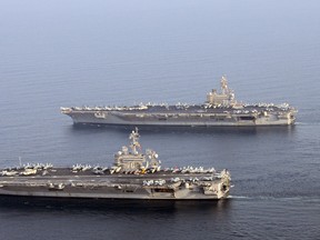 The USS George H.W. Bush (top) where the sailor accused of two violent attacks served until his arrest.