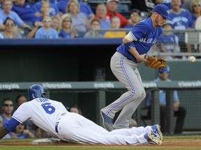 Lorenzo Cain of the Royals slides safely into third base past Josh Donaldson of the Toronto Blue Jays as he advances on an Eric Hosmer single in the fourth inning at Kauffman Stadium in Kansas City on Saturday night.