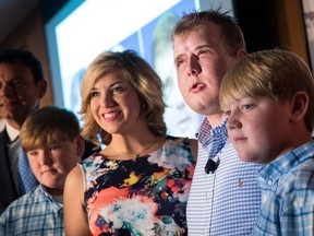 Patrick Hardison (2nd from R), a former firefighter from Mississippi, poses for photos with his children after speaking at a press conference at New York University Langone Medical Center, August 24, 2016 in New York City.