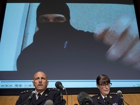 Video footage showing Aaron Driver is seen behind RCMP Deputy Commissioner Mike Cabana and Assistant Commissioner Jennifer Strachan during a press conference.