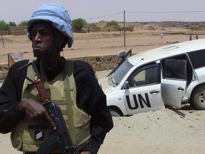 A soldier of the United Nations mission to Mali standing guard near a UN vehicle near Kidal, northern Mali