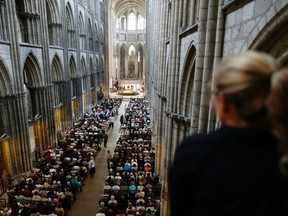 People attend a Mass in tribute to priest Jacques Hamel in the Rouen Cathedral on July 30, 2016.