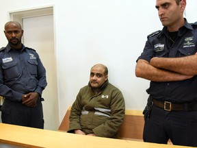 Palestinian Mohammed el-Halabi, the Gaza director of World Vision, a major U.S.-based Christian NGO, looks on during his indictment at a district court in the southern Israeli city of Beersheva on August 4.