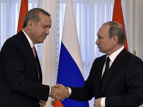 Russian President Vladimir Putin (R) shakes hands with his Turkish counterpart Recep Tayyip Erdogan  during their press conference in Konstantinovsky Palace outside Saint Petersburg on August 9, 2016.