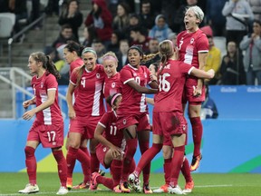 Canada's Sophie Schmidt (R) celebrates with teammates after scoring against France during their Rio 2016 Olympic Games women's football quarterfinal match at the Corinthians Arena in Sao Paulo, Brazil, on August 12, 2016.
