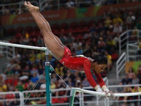 US gymnast Gabrielle Douglas competes in the women's uneven bars event final of the Artistic Gymnastics at the Olympic Arena during the Rio 2016 Olympic Games in Rio de Janeiro on August 14, 2016.