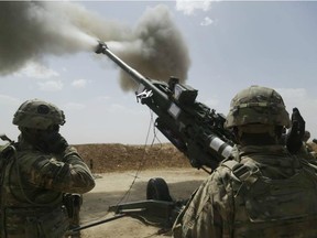 U.S. soldiers fire an M777 howitzer.
